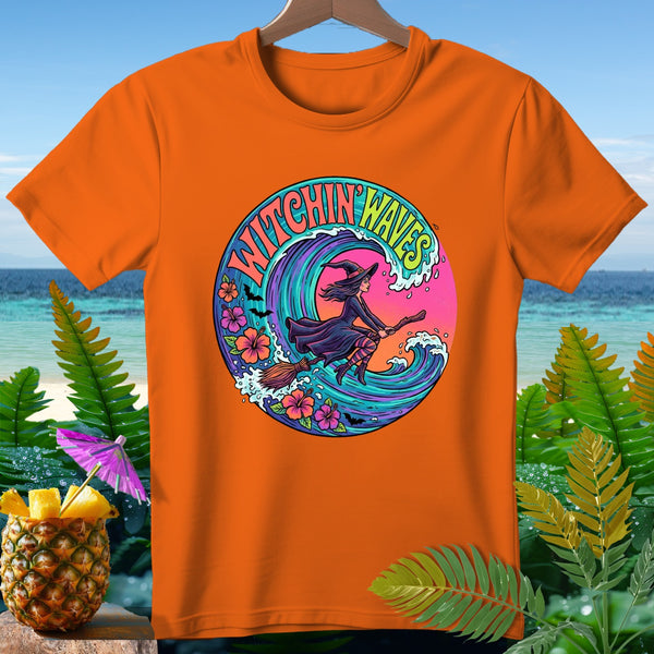 Orange t-shirt with "Witchin' Waves" graphic of a witch on a broomstick riding a wave.