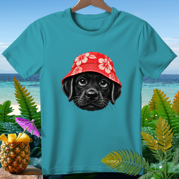 Black puppy wearing a red floral bucket hat on a teal t-shirt.