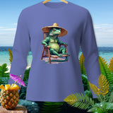 Green iguana wearing a straw hat sits in a chair by the beach.
