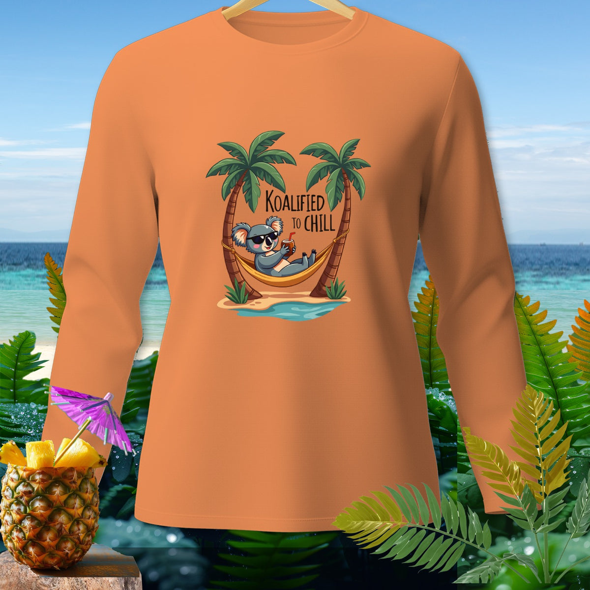 Orange long-sleeve shirt with koala in hammock graphic, "Koalified to Chill" text.
