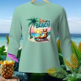 Mint long sleeve shirt with a cartoon fox relaxing on a beach with text 