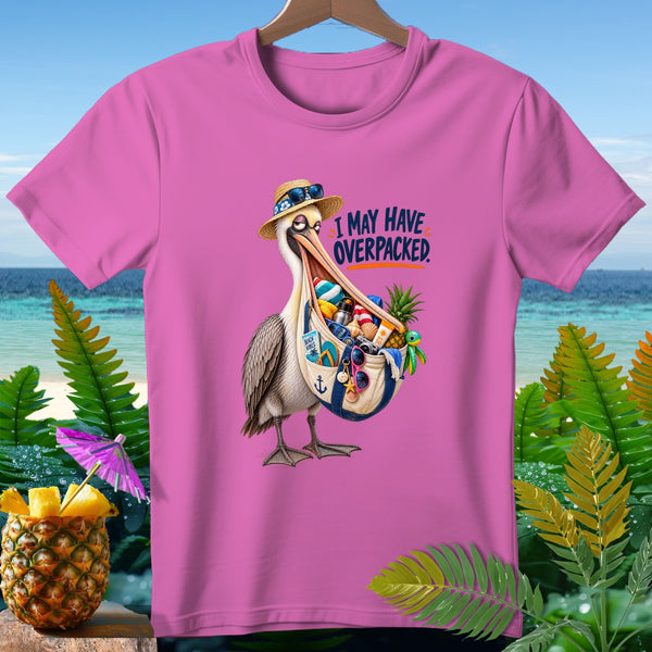Pink t-shirt with a pelican wearing a straw hat and sunglasses, holding a bag full of beach items, text says "I MAY HAVE OVERPACKED."