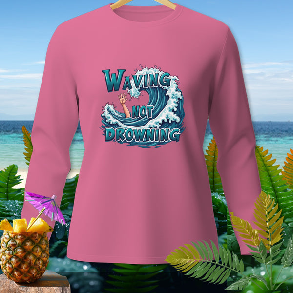 Pink long-sleeve shirt with "Waving Not Drowning" text over a wave graphic.