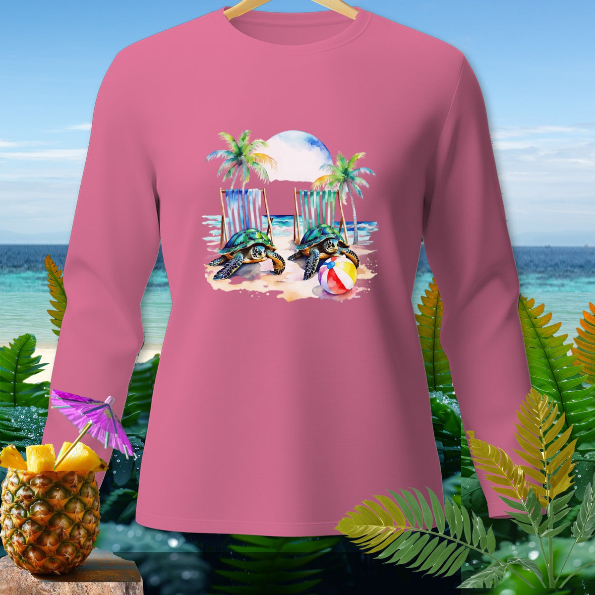 Pink long-sleeve shirt with two sea turtles and beach chairs graphic.