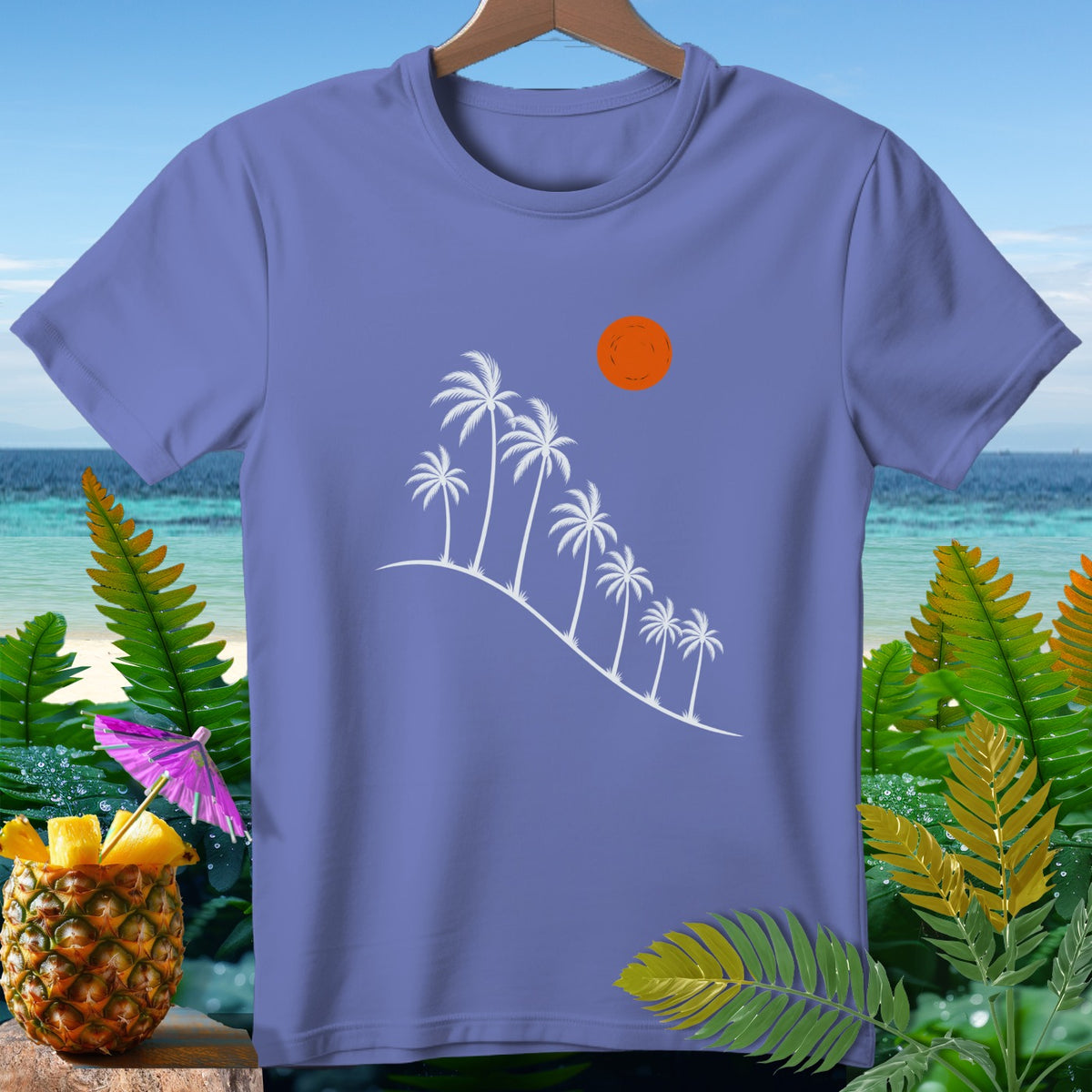 Purple t-shirt with white palm trees, orange sun, and tropical background.