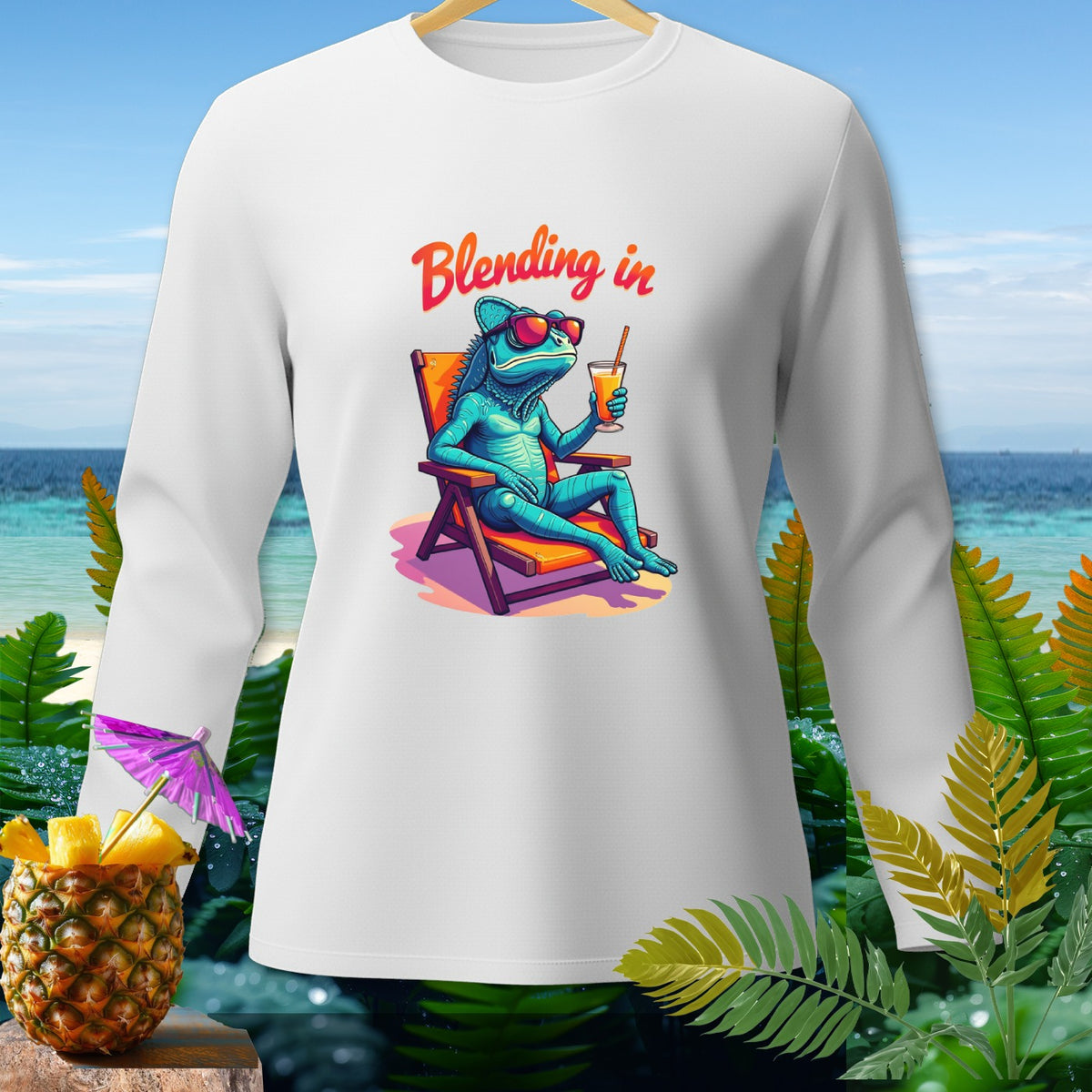 White long-sleeve shirt with a blue chameleon lounging in a beach chair and text "Blending in".