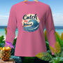 Pink long-sleeve shirt with "Catch the Wave" graphic and tropical background.