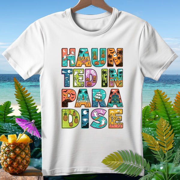 White t-shirt with colorful "Haunted in Paradise" text featuring Halloween beach themes.