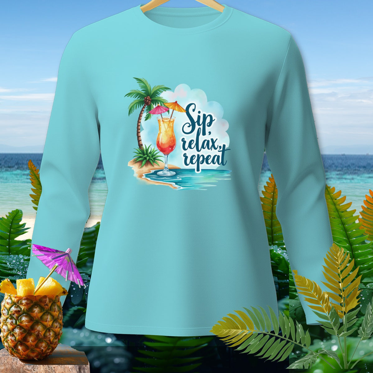 Light blue long-sleeve shirt with a tropical beach graphic and "Sip, relax, repeat" text.
