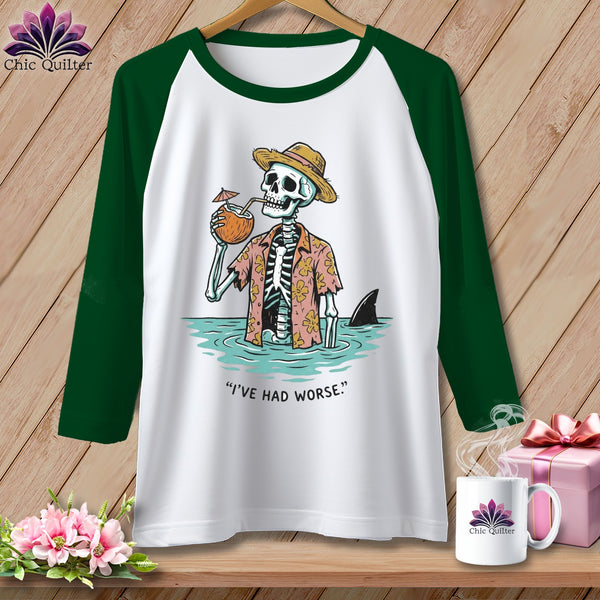 Green sleeve raglan shirt with skeleton in Hawaiian shirt drinking coconut and shark fin.