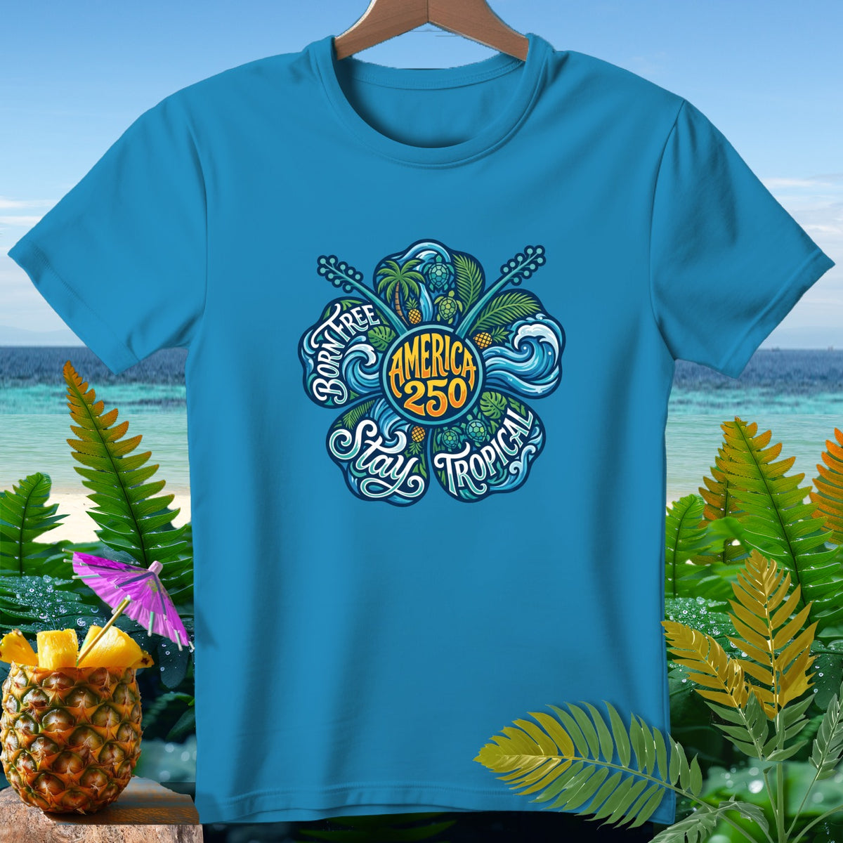 Blue t-shirt with circular "America 250" graphic and "Born Free Stay Tropical" text.