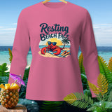 Pink long-sleeve shirt with a graphic of a lobster wearing sunglasses on a beach.