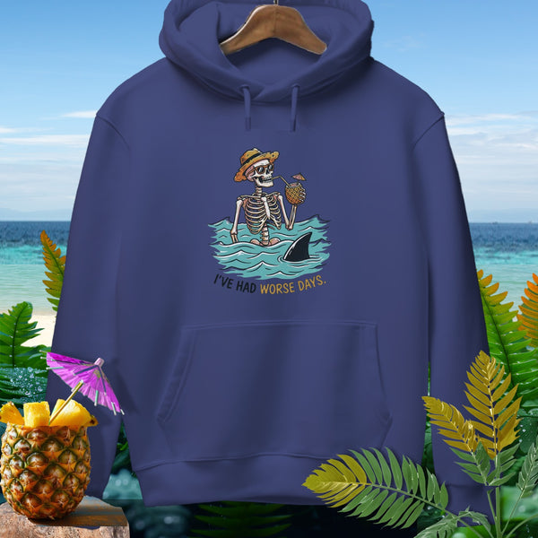 Skeleton in water with shark and pineapple drink, text "I'VE HAD WORSE DAYS."
