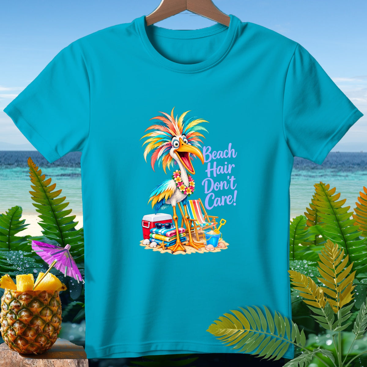 Turquoise t-shirt with a colorful cartoon bird and text "Beach Hair Don't Care!"