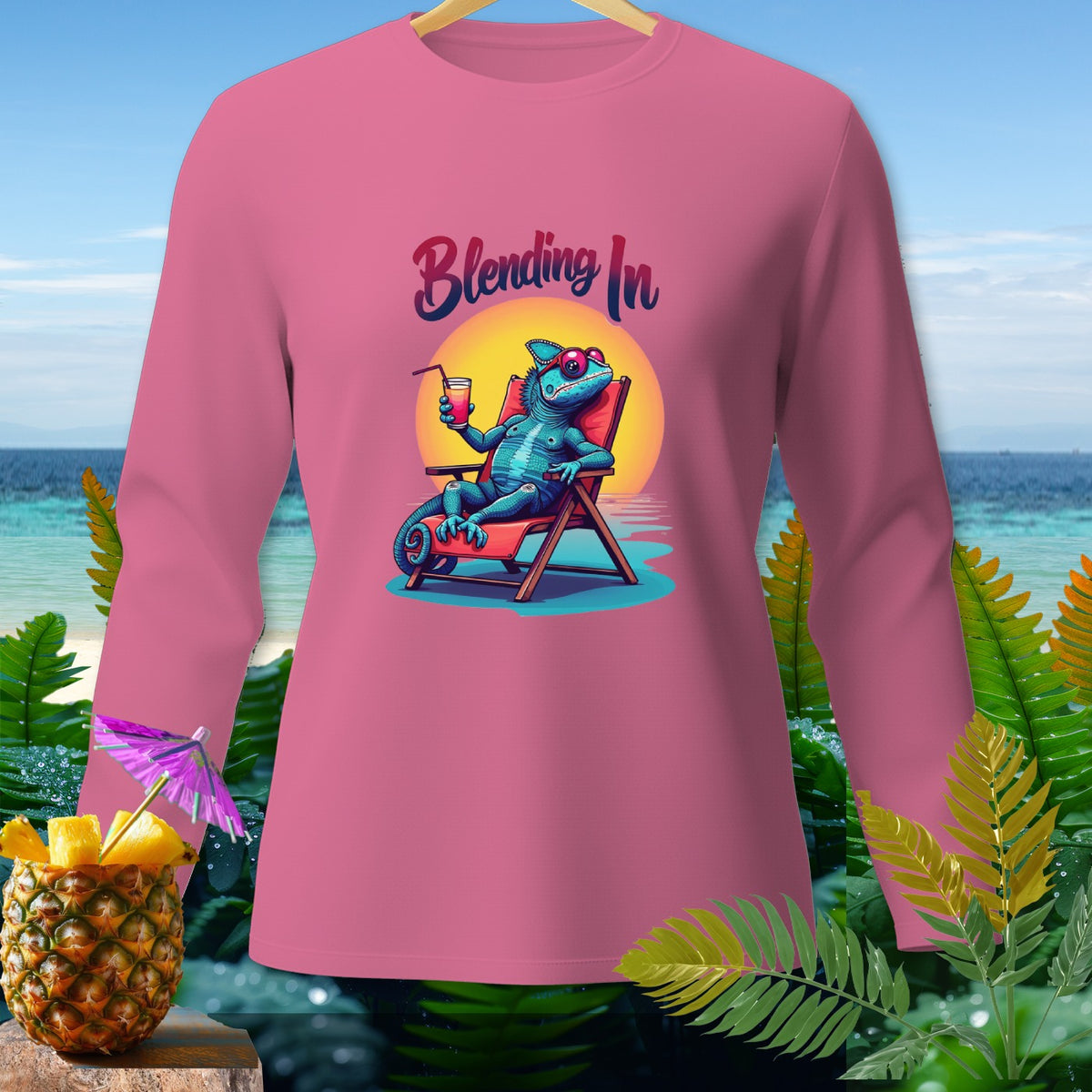 Pink long sleeve shirt with "Blending In" text and a chameleon on a beach chair.
