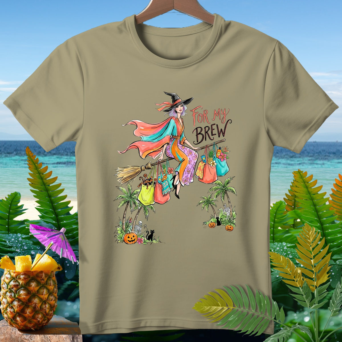 Witch on broom with shopping bags, "For My Brew," on khaki t-shirt.