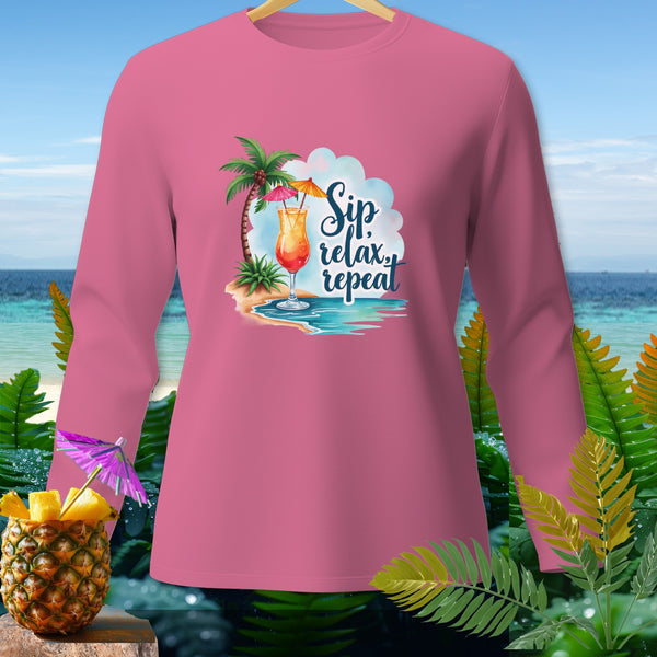 Pink long-sleeve shirt with tropical beach graphic and "Sip, relax, repeat" text.
