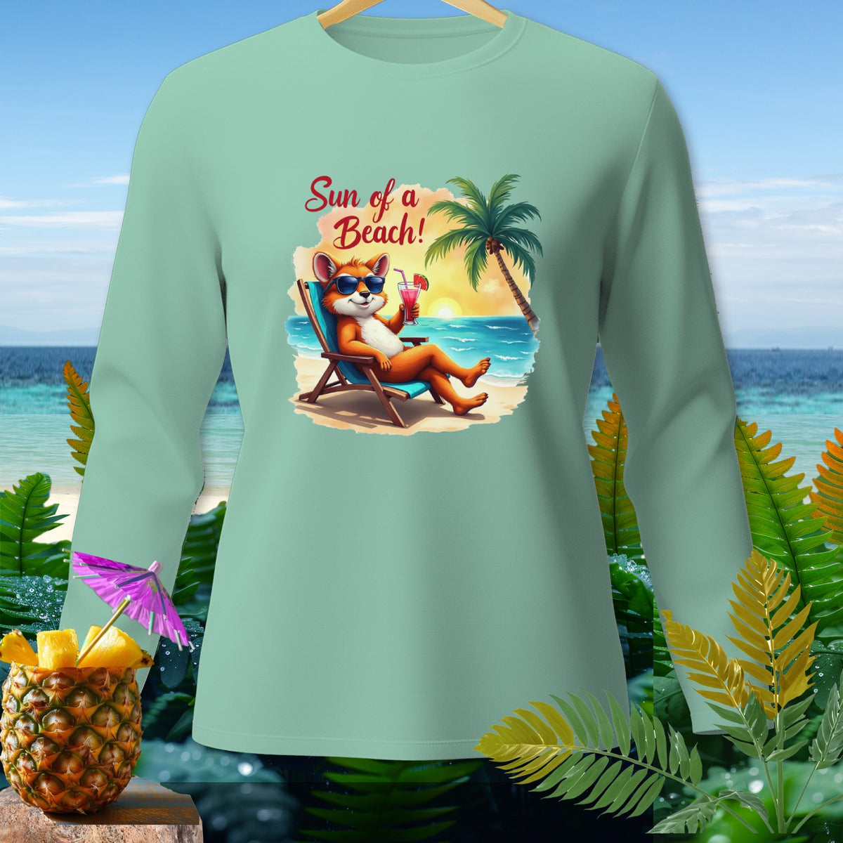 Light green long sleeve shirt with cartoon fox on beach graphic and "Sun of a Beach!" text.