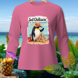 Pink long sleeve shirt with a penguin building a sandcastle and the text 