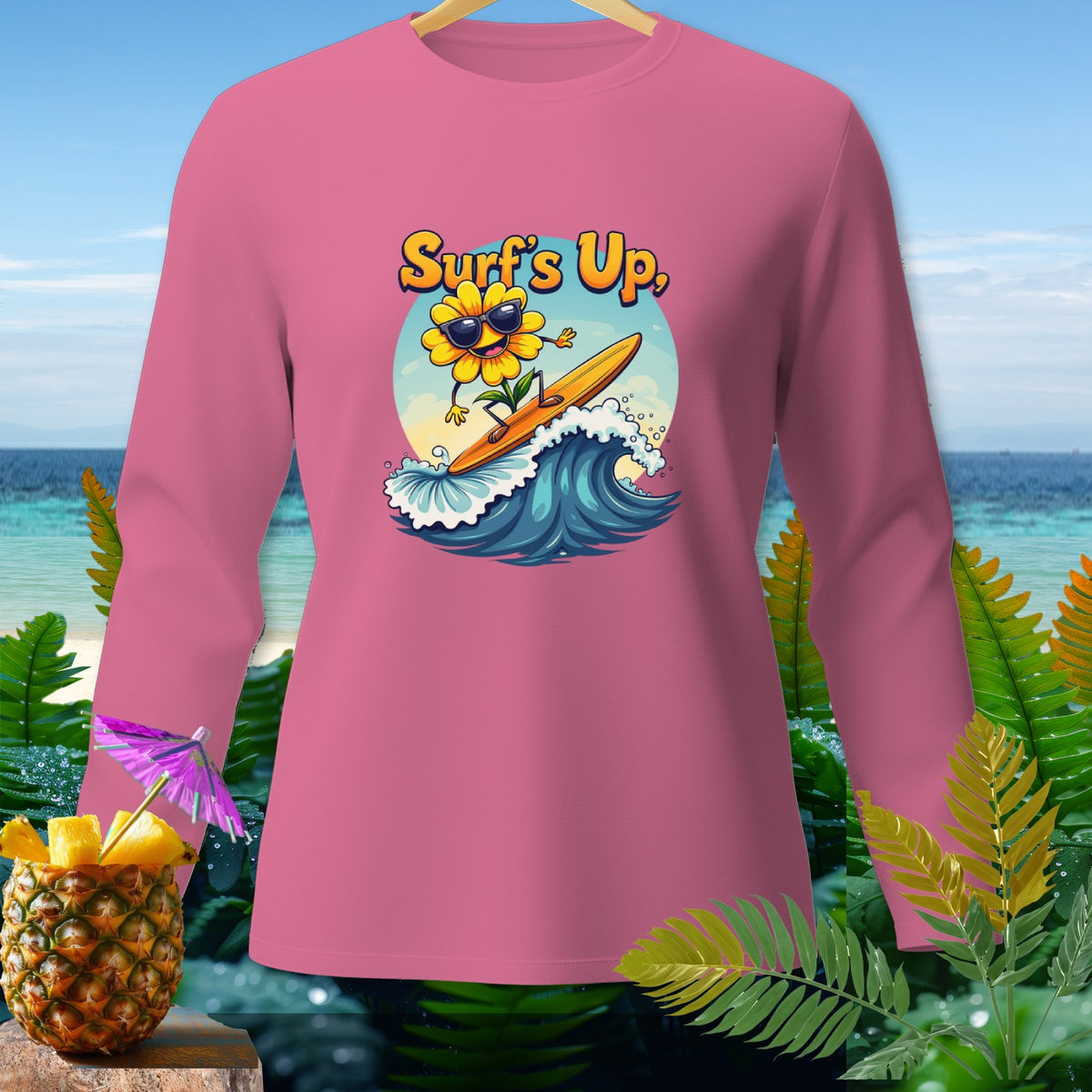 Pink long-sleeve shirt with a cartoon sunflower surfing and text "Surf's Up,"