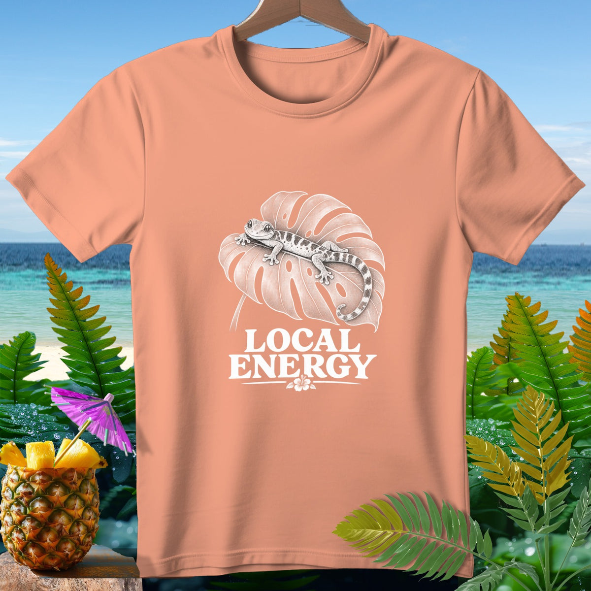 Peach t-shirt with gecko on leaf and text "LOCAL ENERGY".