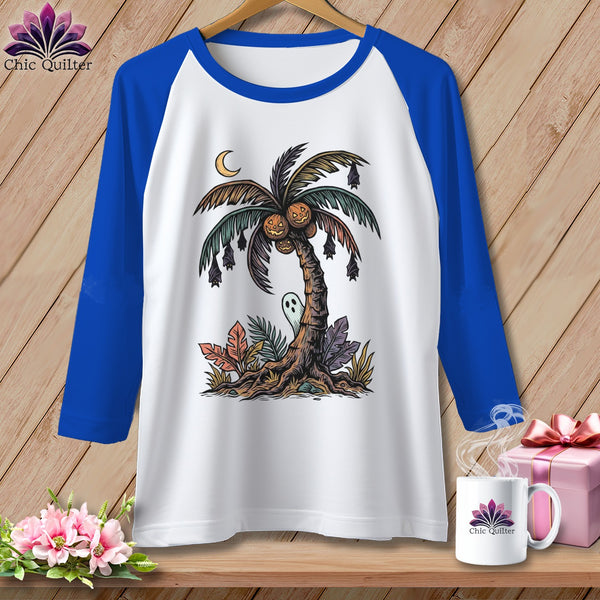 White raglan t-shirt with a Halloween-themed palm tree graphic featuring pumpkins, bats, and a ghost.