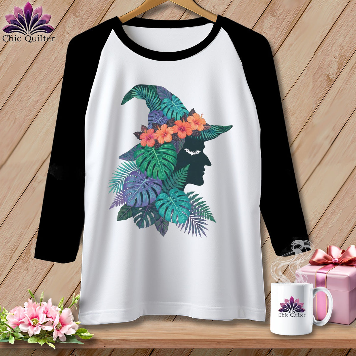 Raglan shirt with witch hat and tropical foliage graphic.