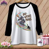 T-shirt with a witch on a surfboard and black cat, text reads 