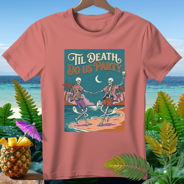 Pink t-shirt with "Til Death Do Us Party" graphic of dancing skeletons on a beach.