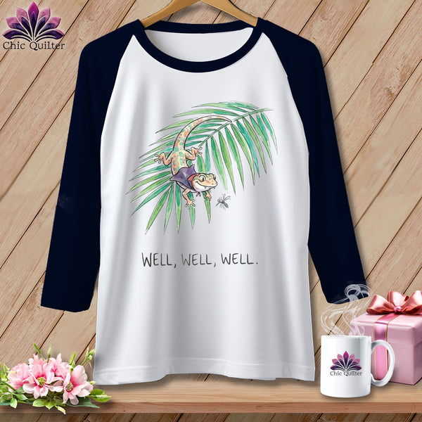 White baseball tee with cartoon gecko on palm frond, "WELL, WELL, WELL." text.