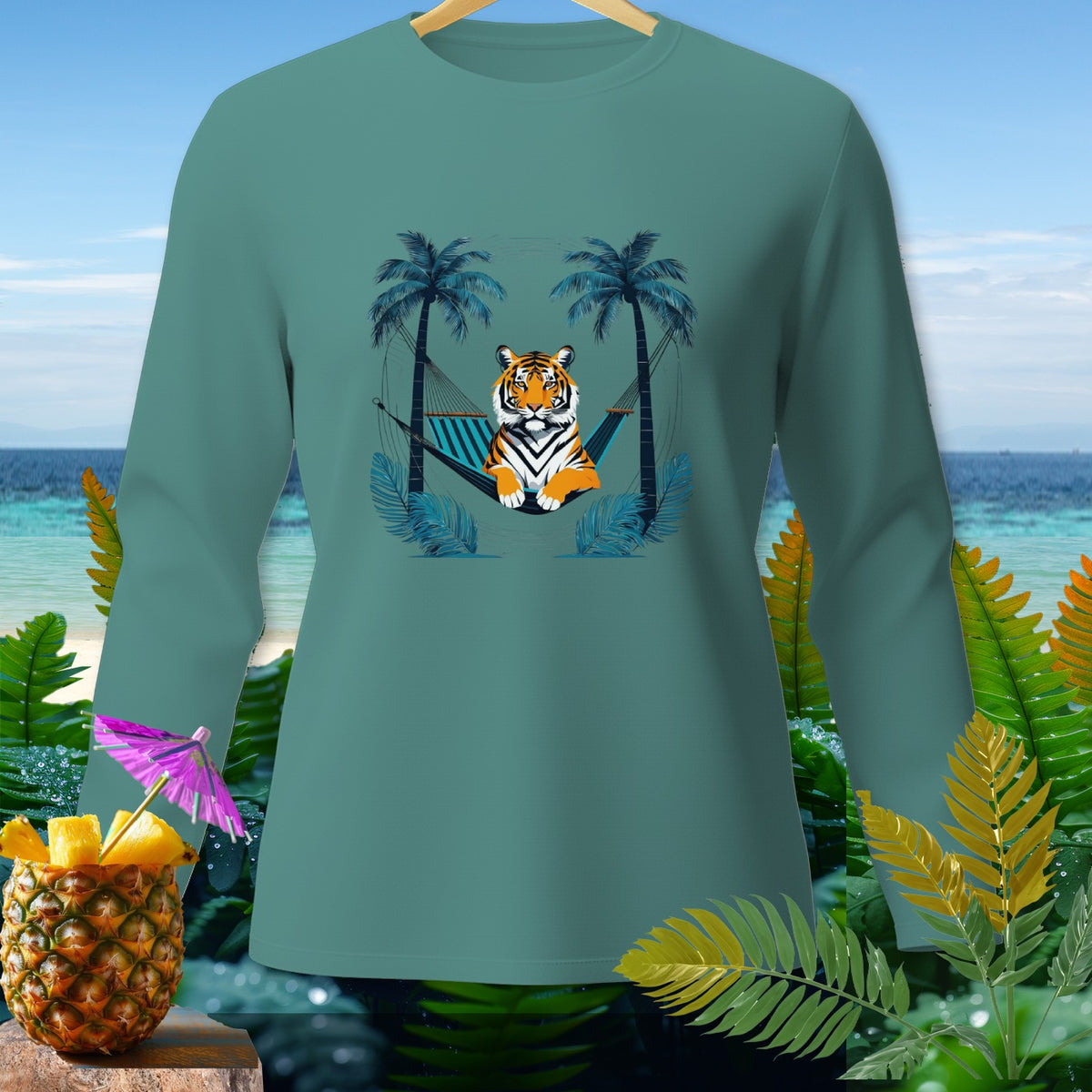 Tiger lounging in a hammock between palm trees on a teal long-sleeved shirt.