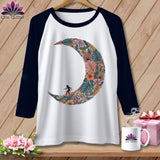 Raglan sleeve t-shirt with a crescent moon floral design and surfer silhouette.