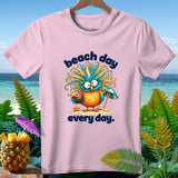 Pink t-shirt with cartoon owl holding a coconut drink and an umbrella, text 