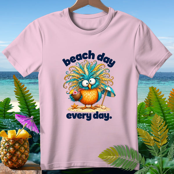 Pink t-shirt with cartoon owl holding a coconut drink and an umbrella, text "beach day every day".