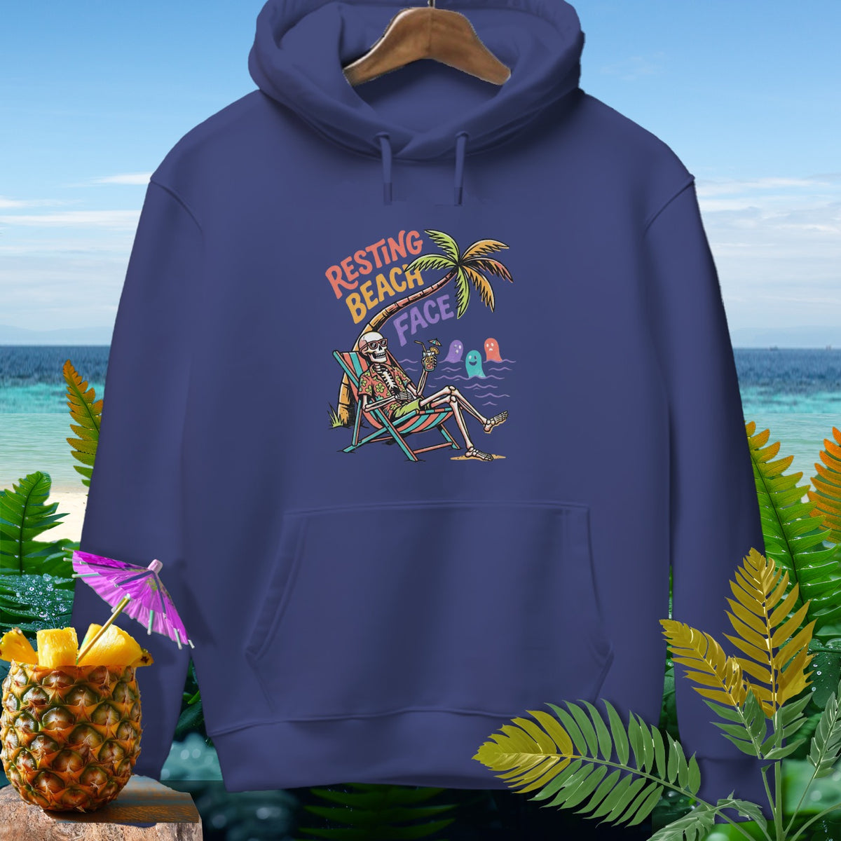 Skeleton in beach chair with "Resting Beach Face" text, cartoon ghosts, pineapple and palm tree.