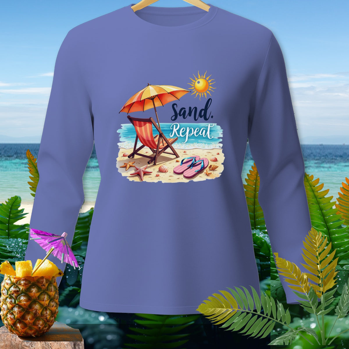 Purple long-sleeve shirt with "Sand. Repeat" beach graphic.