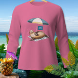 Pink long-sleeved shirt with a seal relaxing under an umbrella with a 