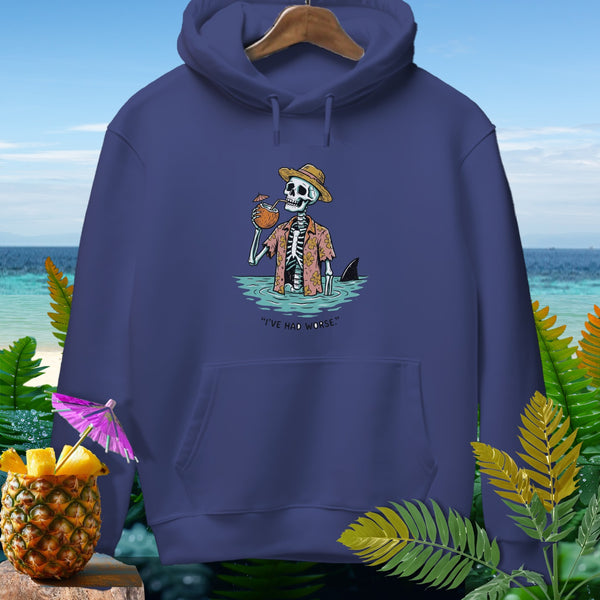 Dark blue hoodie featuring a skeleton in a hat drinking from a coconut with a shark fin visible.
