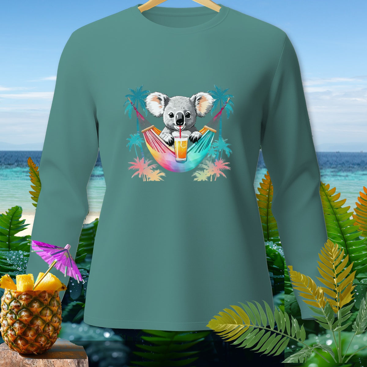 Teal long-sleeve shirt with graphic of koala in hammock drinking juice with palm trees.