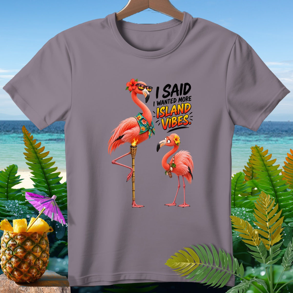 T-shirt graphic with two flamingos and text "I Said I Wanted More Island Vibes".
