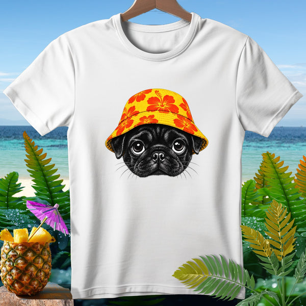 White t-shirt with a black pug wearing a yellow hibiscus bucket hat on beach background.