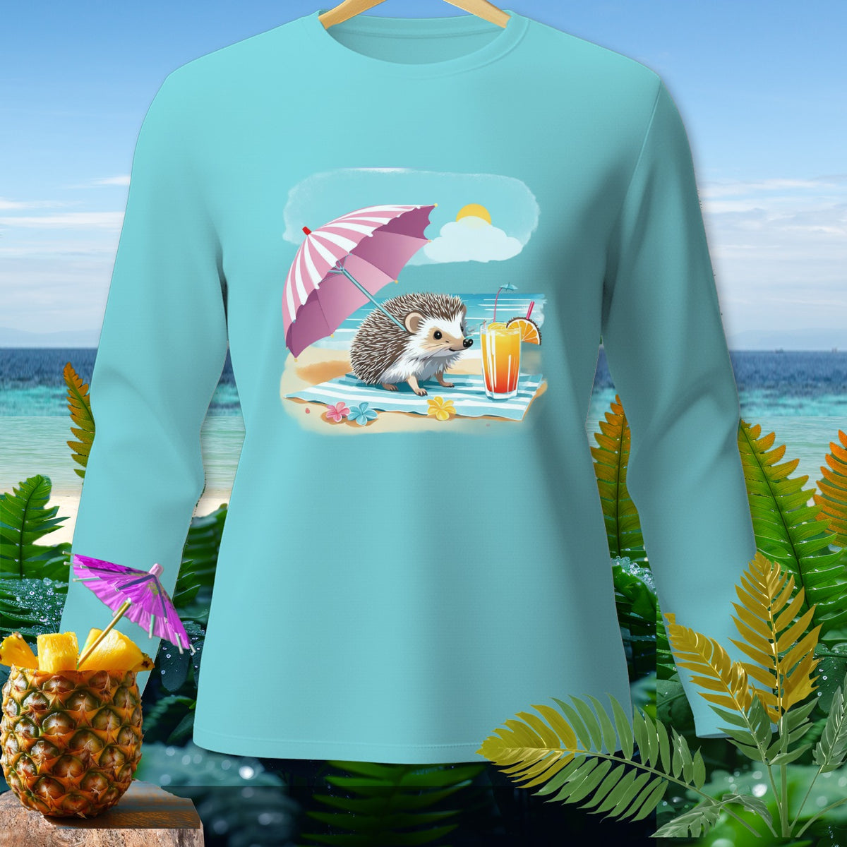 Light blue long-sleeve shirt with a graphic of a hedgehog on a beach with an umbrella and drink.