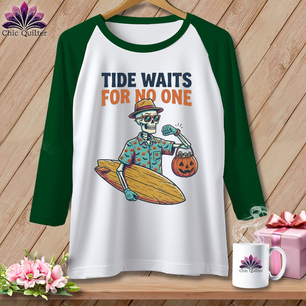 White t-shirt with green sleeves featuring a skeleton holding a surfboard and pumpkin.