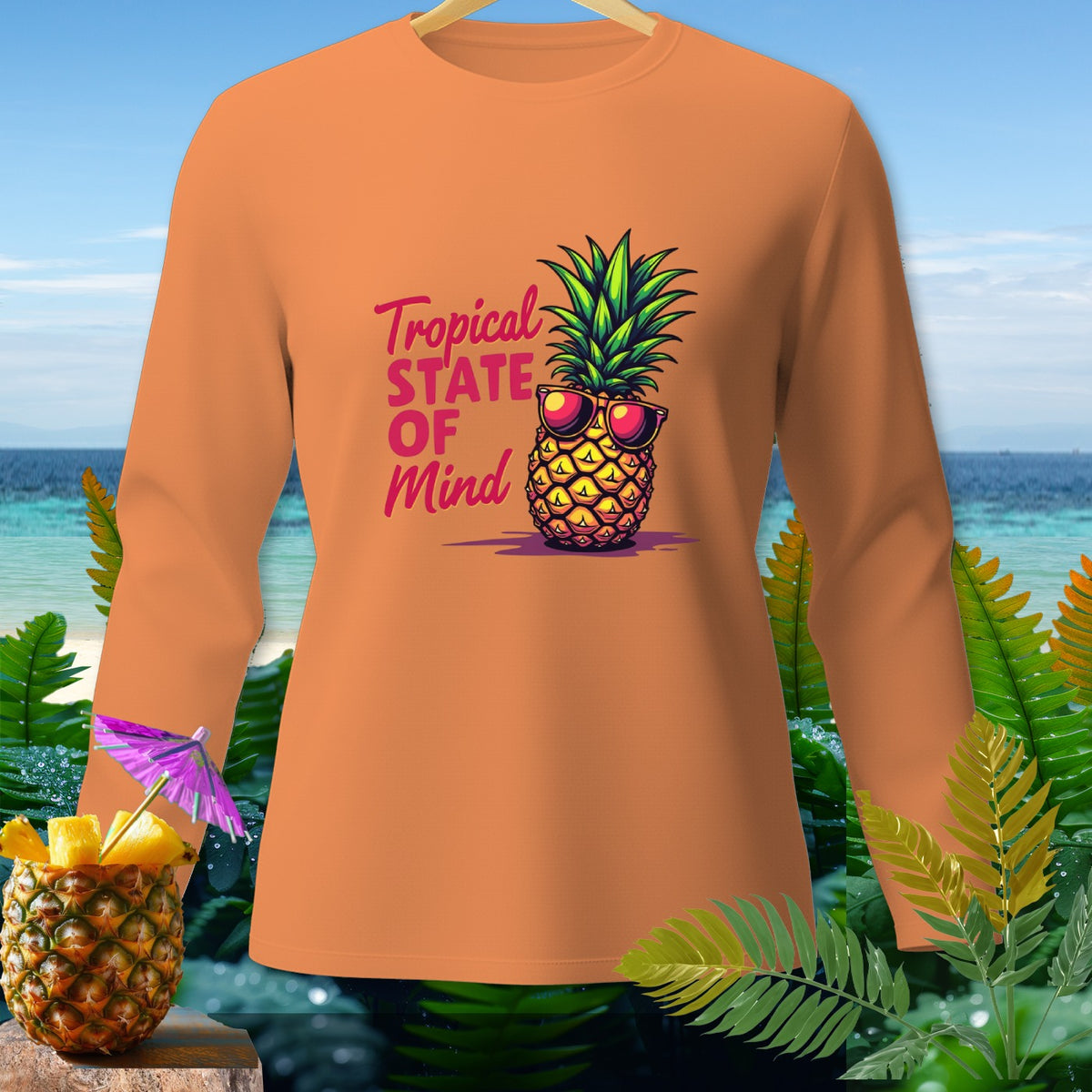Orange long-sleeve shirt with a pineapple wearing sunglasses and text "Tropical State Of Mind."