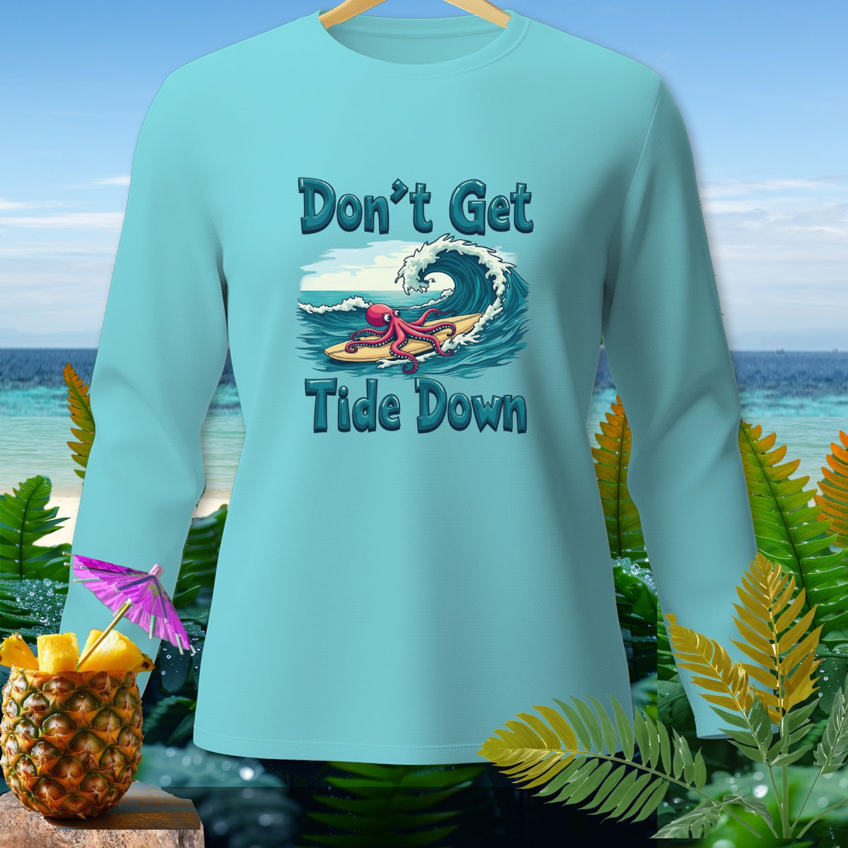 Light blue long-sleeve shirt with octopus surfing graphic and text "Don't Get Tide Down".
