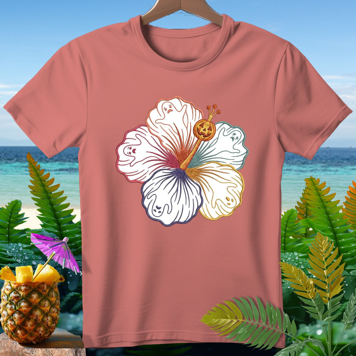 Coral t-shirt with hibiscus graphic featuring ghosts and a jack-o'-lantern.