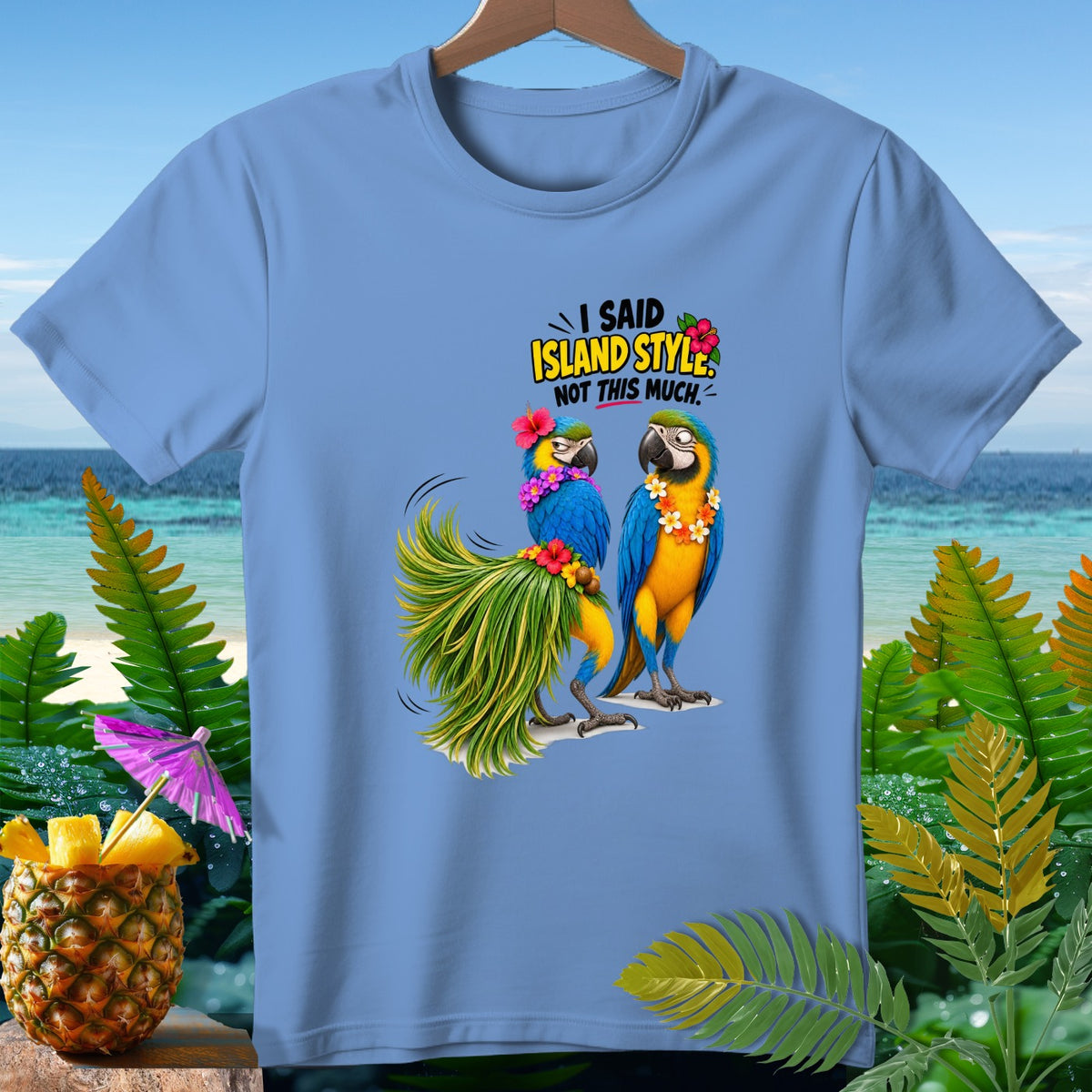 Blue t-shirt with two macaws, one in a grass skirt, and text "Island Style. Not This Much."