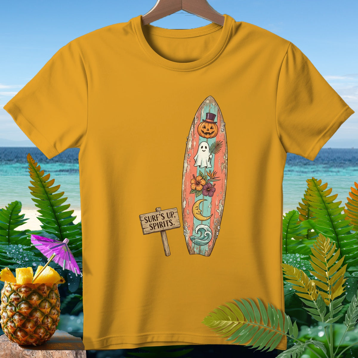 Yellow t-shirt with surfboard graphic featuring a pumpkin, ghost, and tropical flowers.