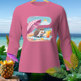 Pink long sleeve shirt with a graphic of a hedgehog on the beach with an umbrella and drink.