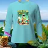 Light blue long-sleeve shirt with a meerkat holding a drink on a beach.